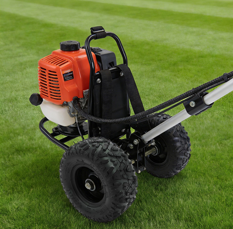 Gas-powered wheeled garden tiller on a green lawn for yard work.